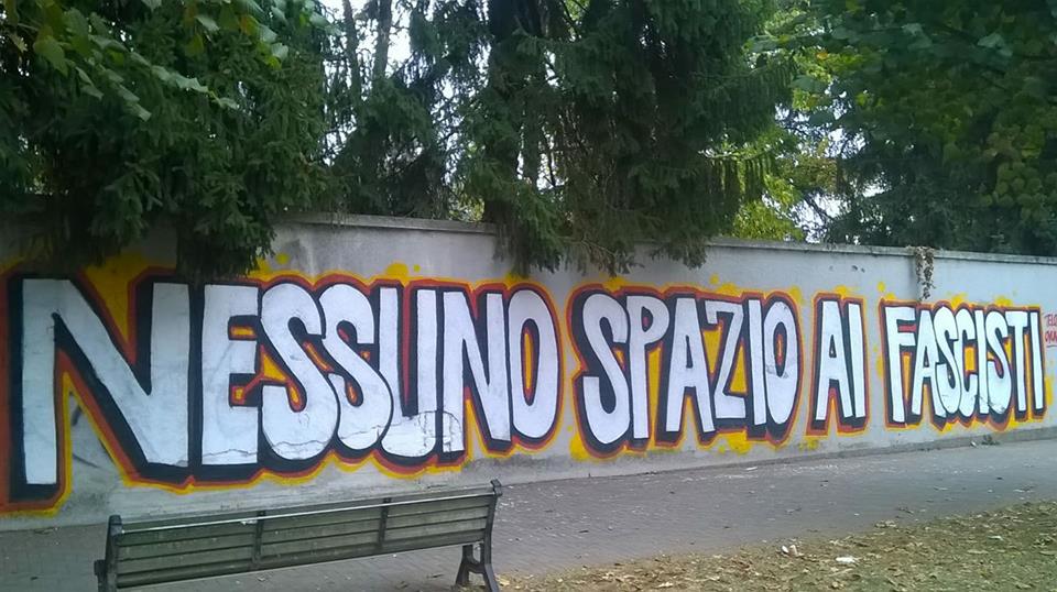 Telos: graffito realizzato in pieno giorno in via Varese. Volantinaggio fuori dalle scuole
