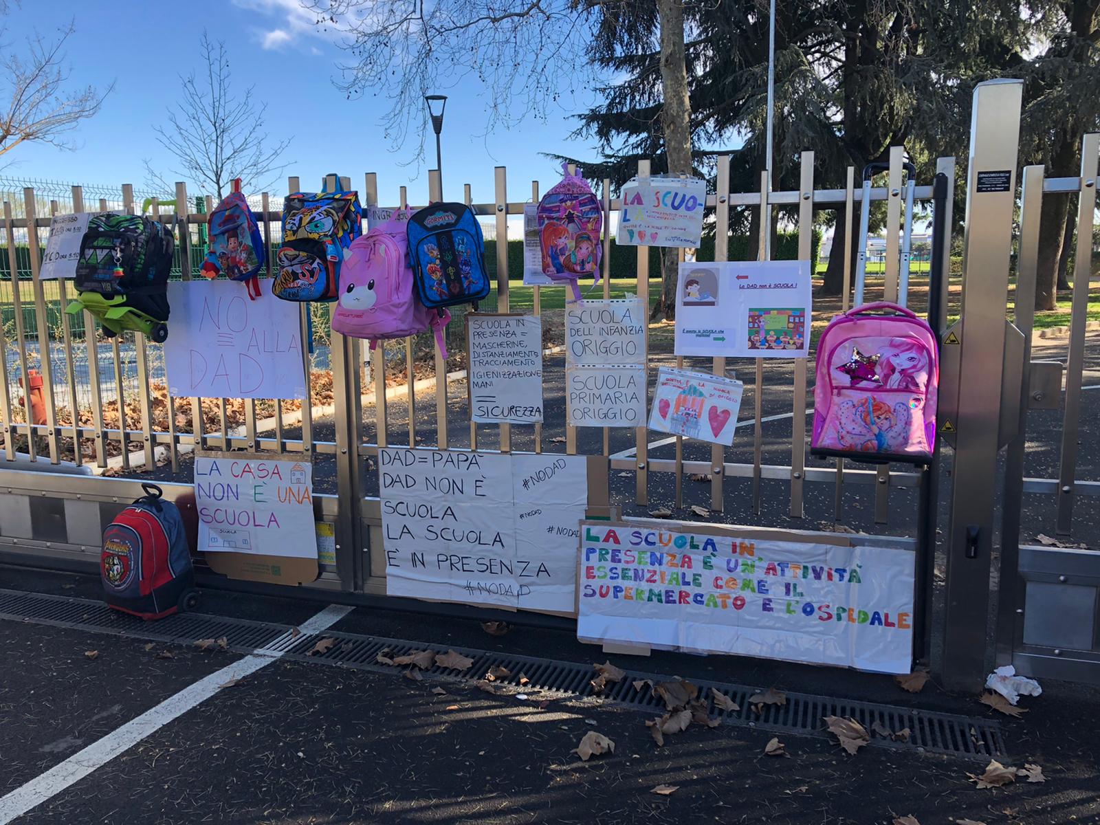 Origgio, cartelloni e cartelle sul cancello della scuola.Mamme e papà: “Basta alla Dad”