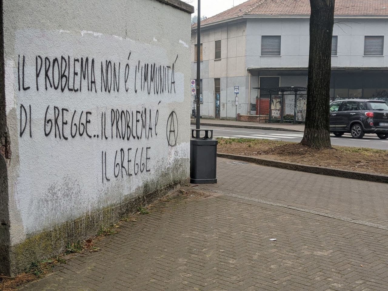 Nuovo blitz anti greenpass sui muri saronnesi con maxi graffito antifascista e simboli anarchici